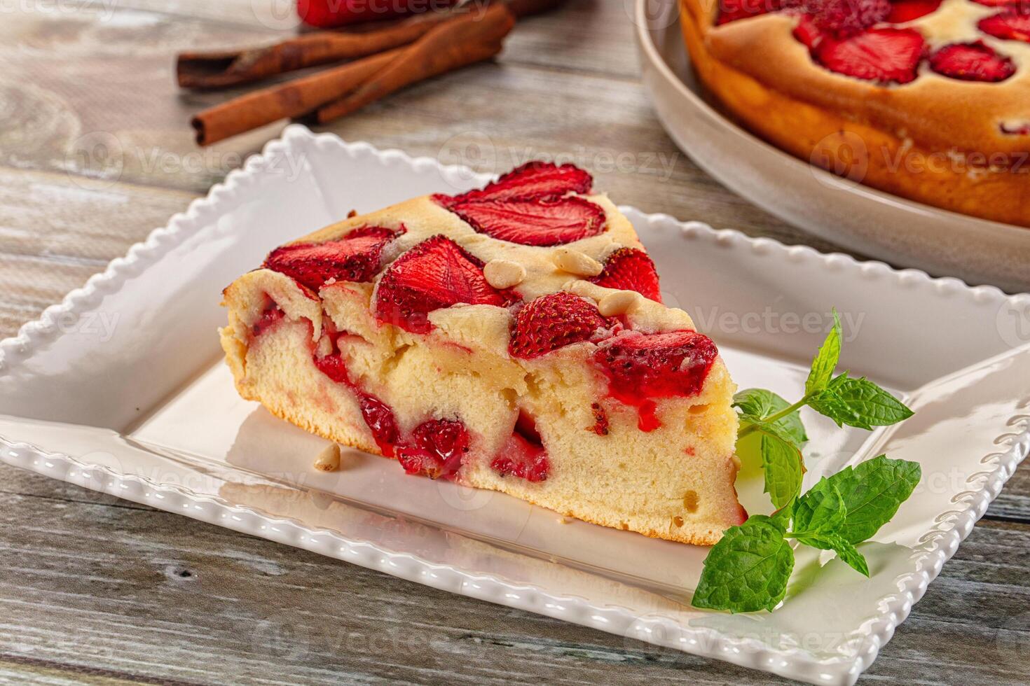 A slice of cake on a plate with strawberries photo