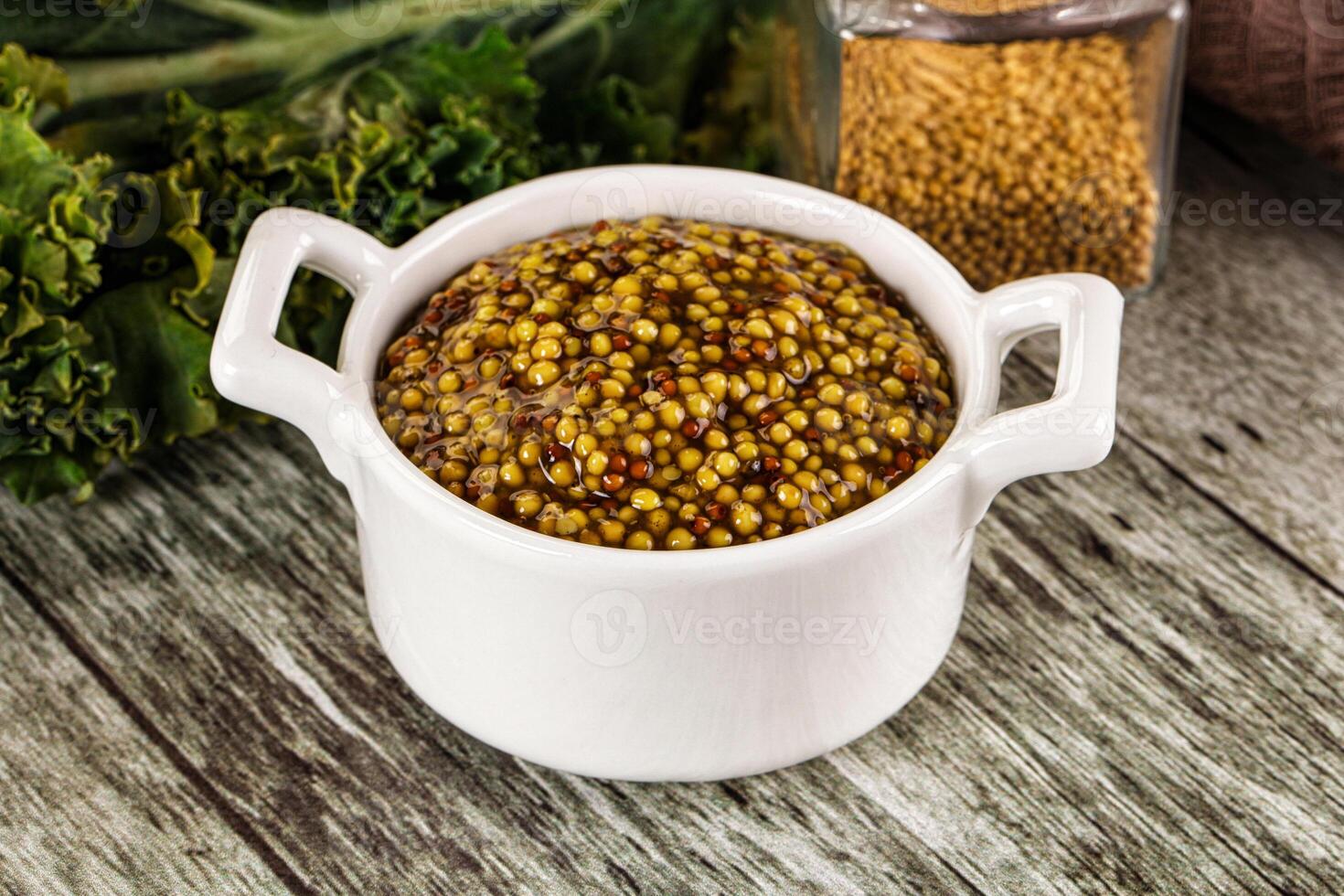 A white cup filled with mustard photo