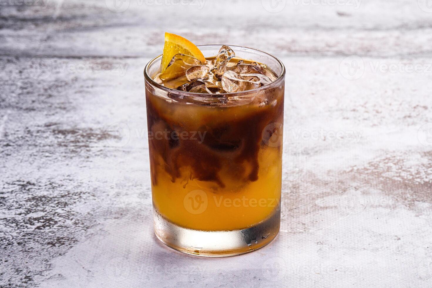 An iced coffee with orange slices on top photo
