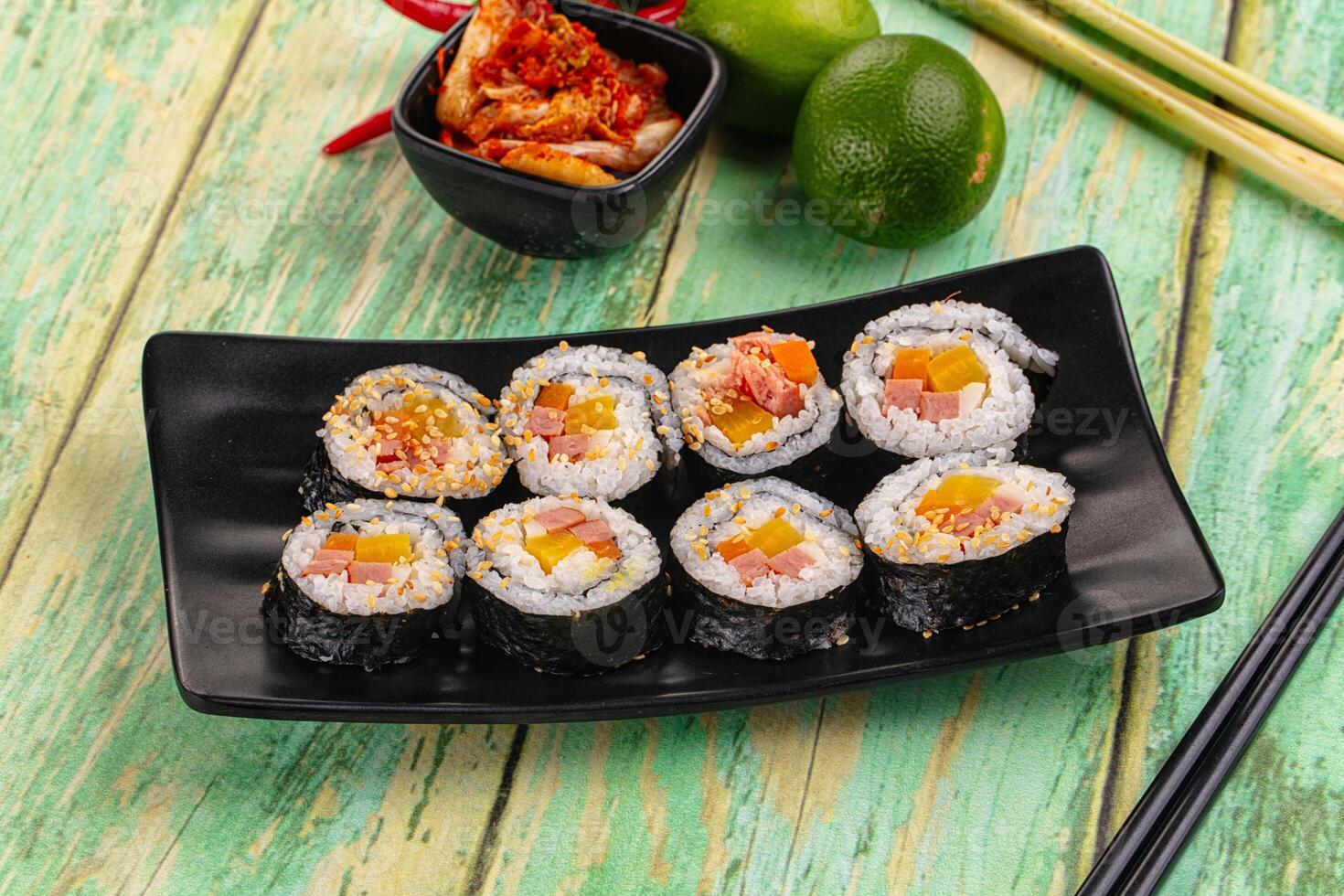 Sushi rolls with vegetables and other ingredients on a black plate photo