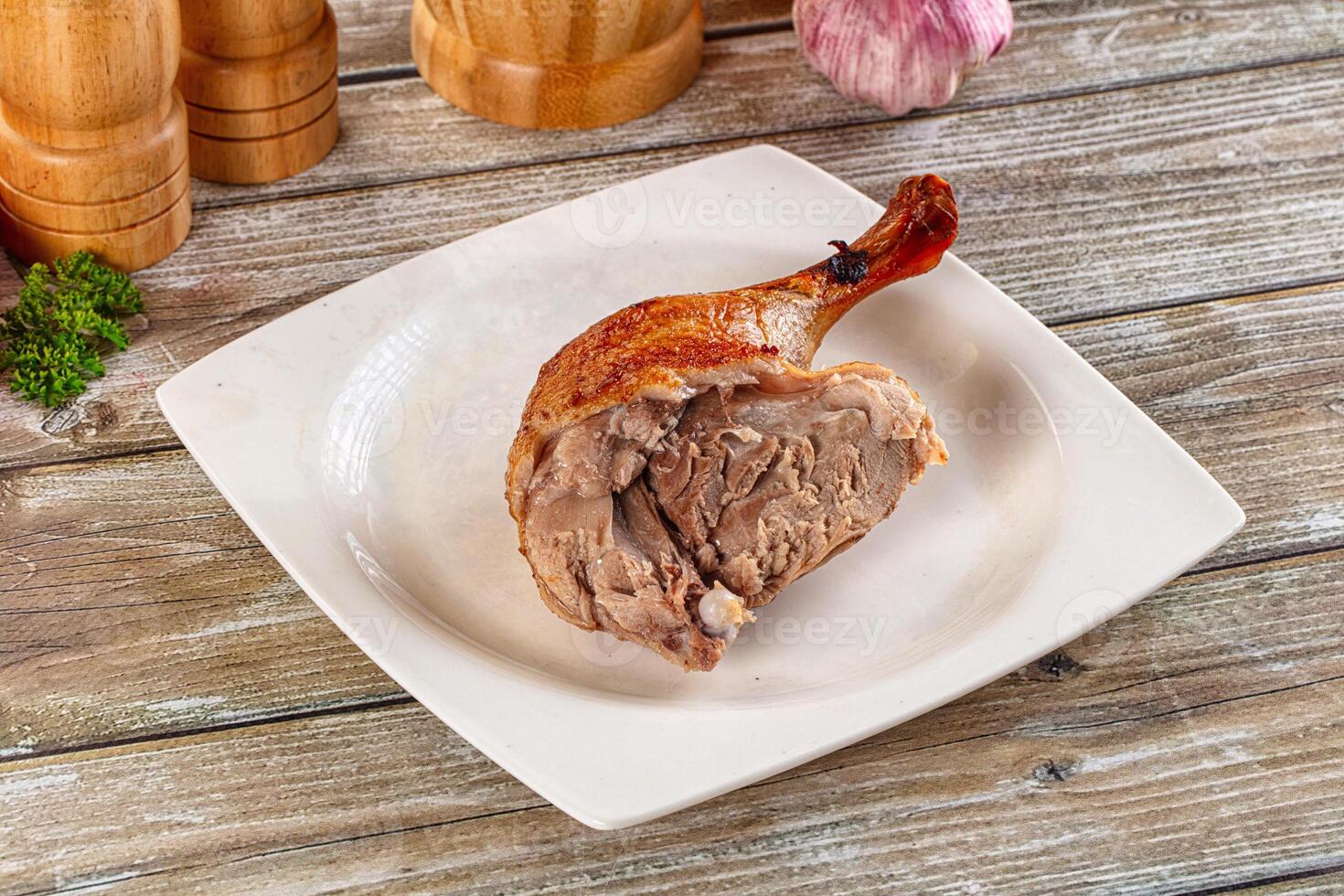 A piece of meat on a plate with garlic and spices photo