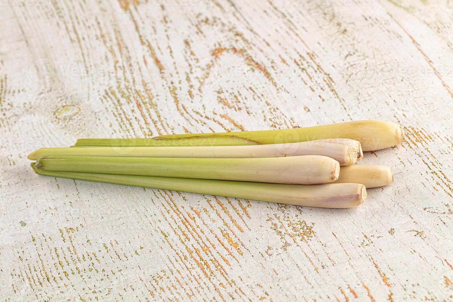 Three pieces of green leeks on a wooden surface photo