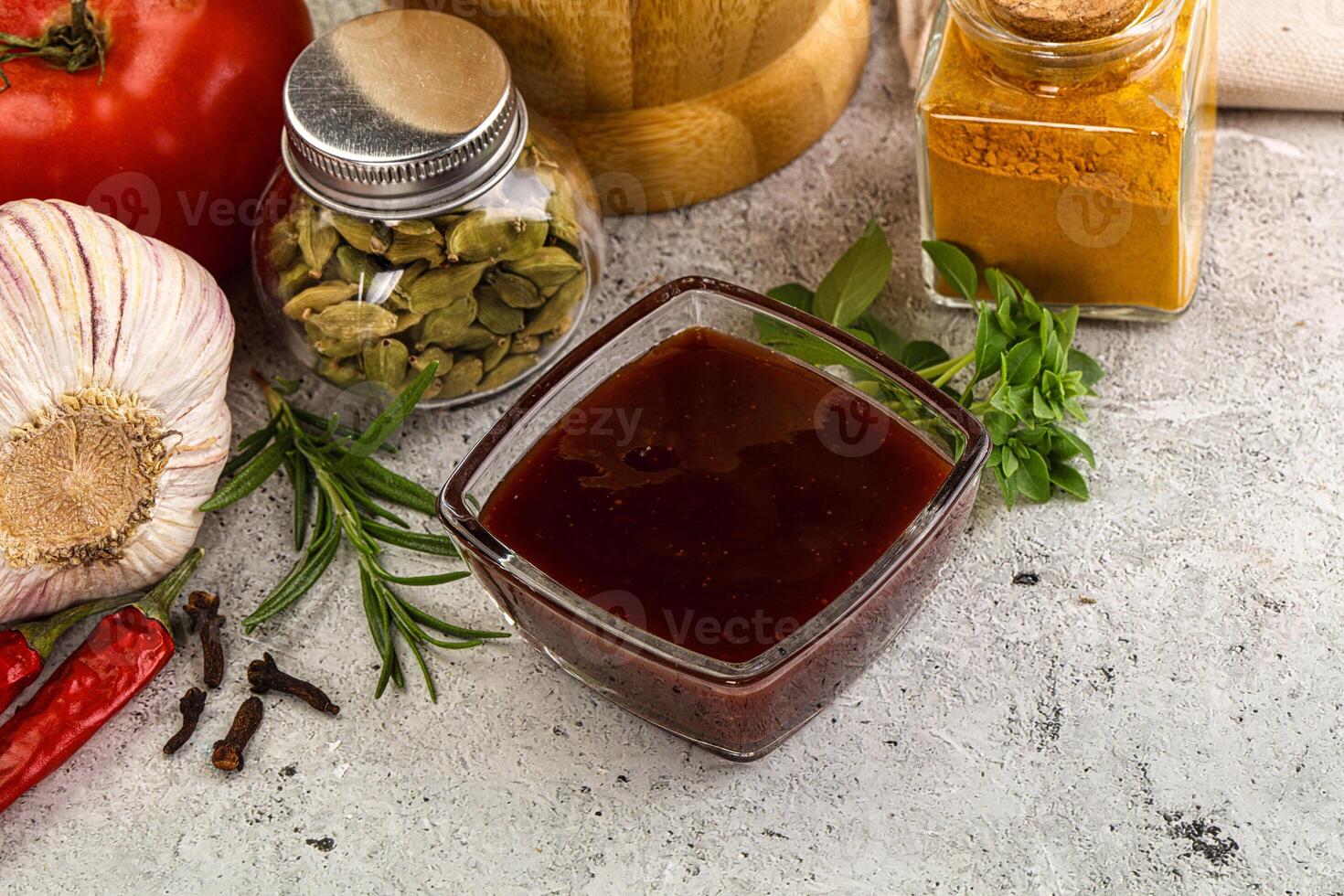 A bunch of spices and vegetables on a table photo