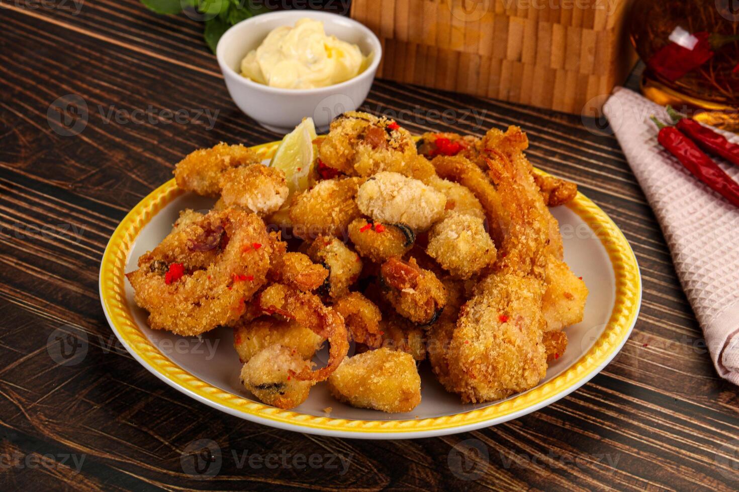 Fried shrimp on a plate with a bottle of beer photo
