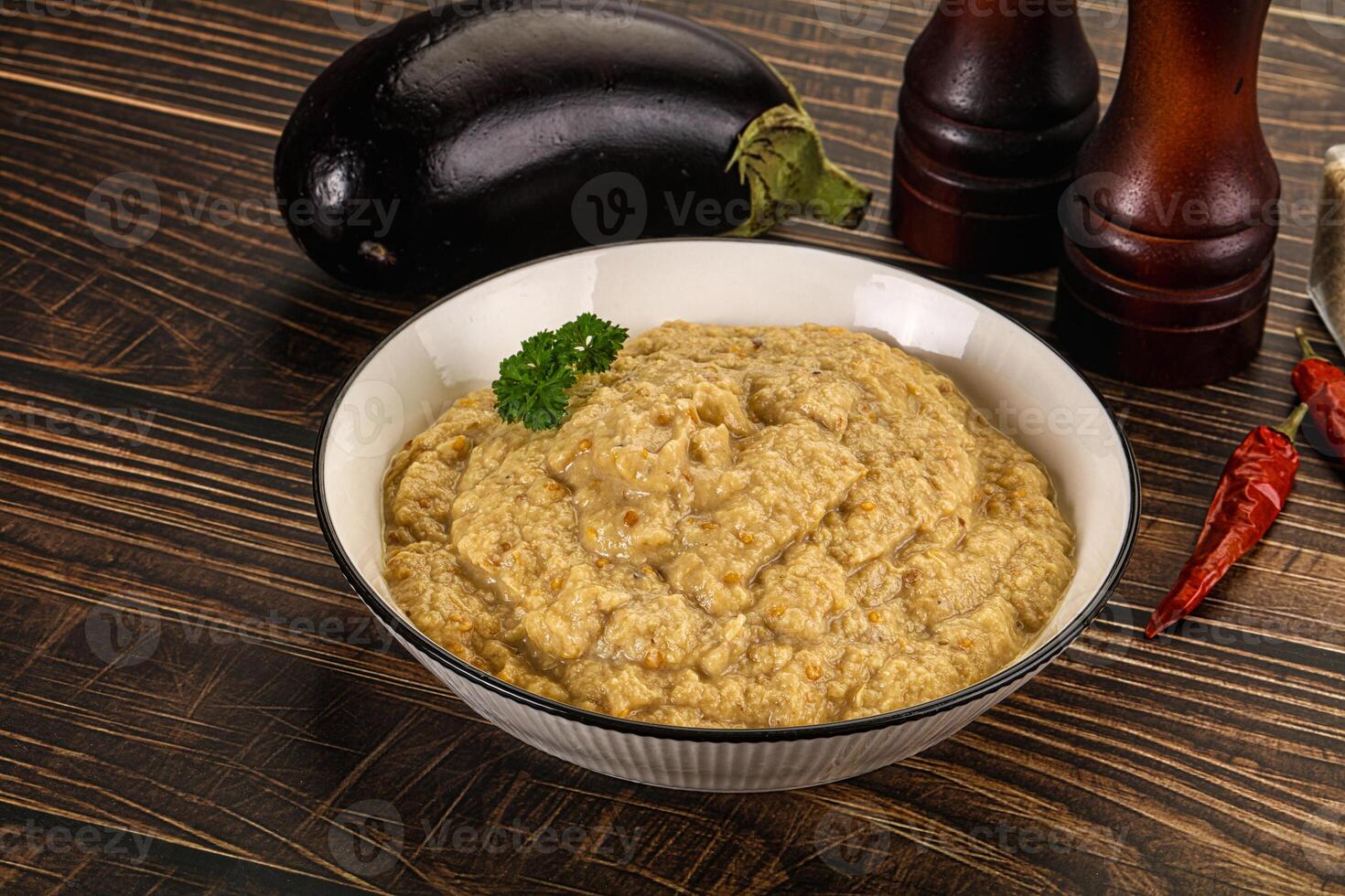 A bowl of eggplant dip with some spices and other ingredients photo