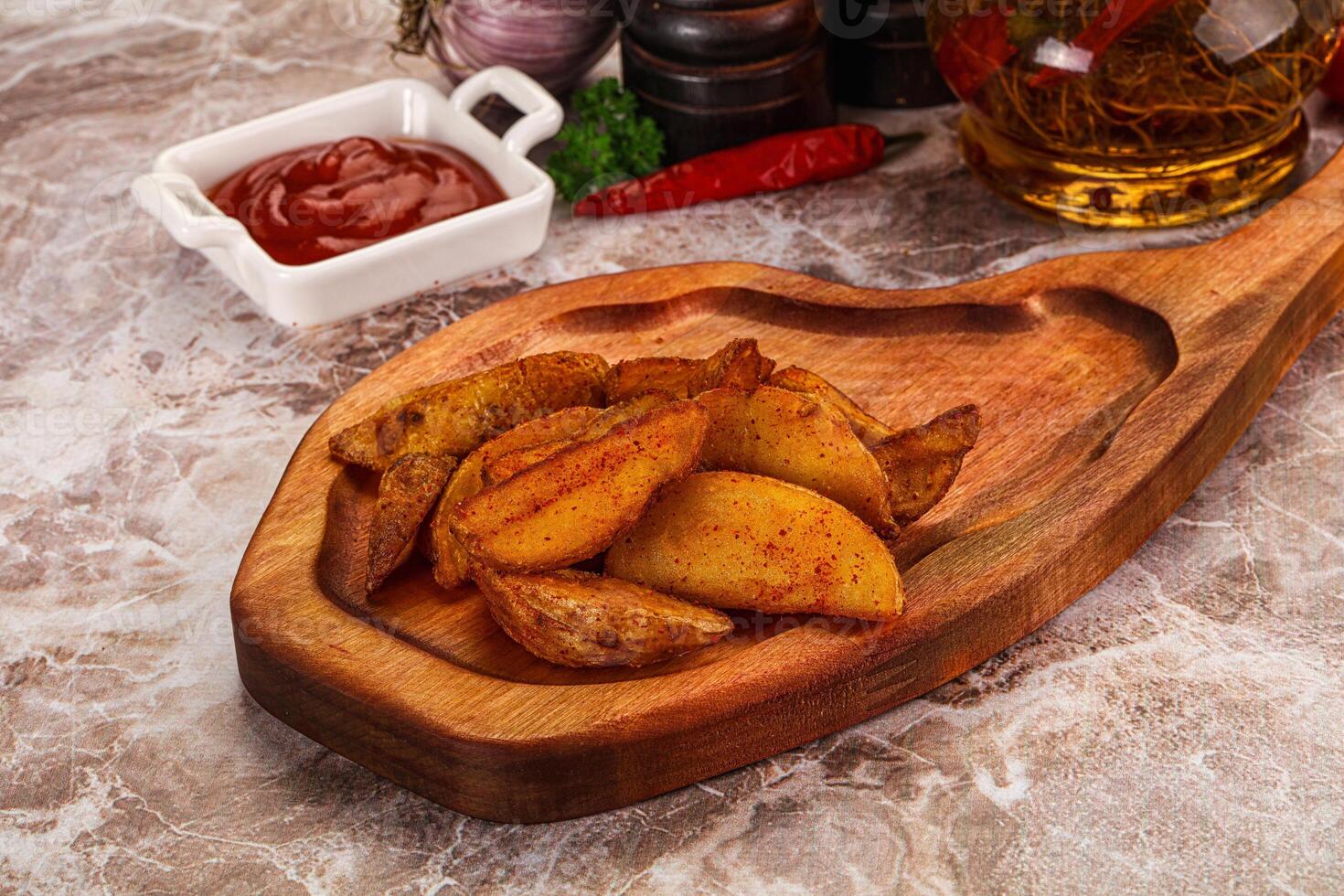 A wooden cutting board with potatoes and other ingredients photo