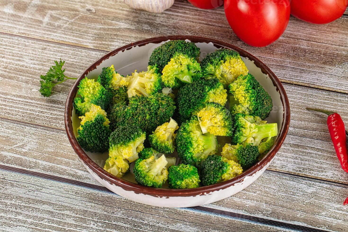 Broccoli in a bowl with tomatoes and garlic photo