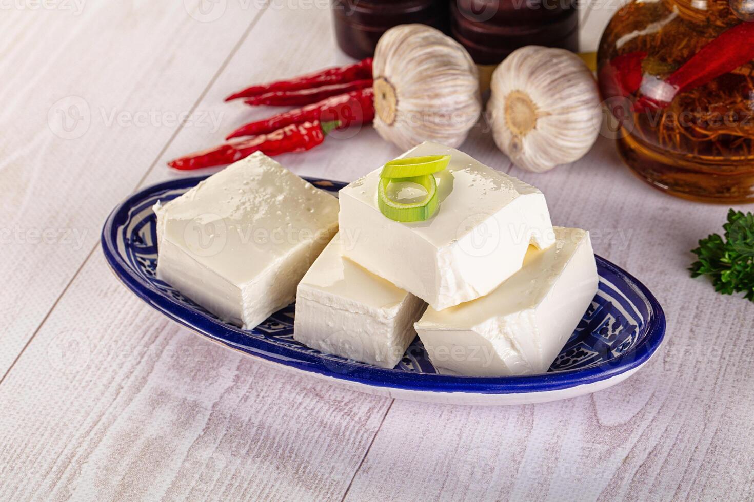 A plate with cubes of cheese and garlic photo