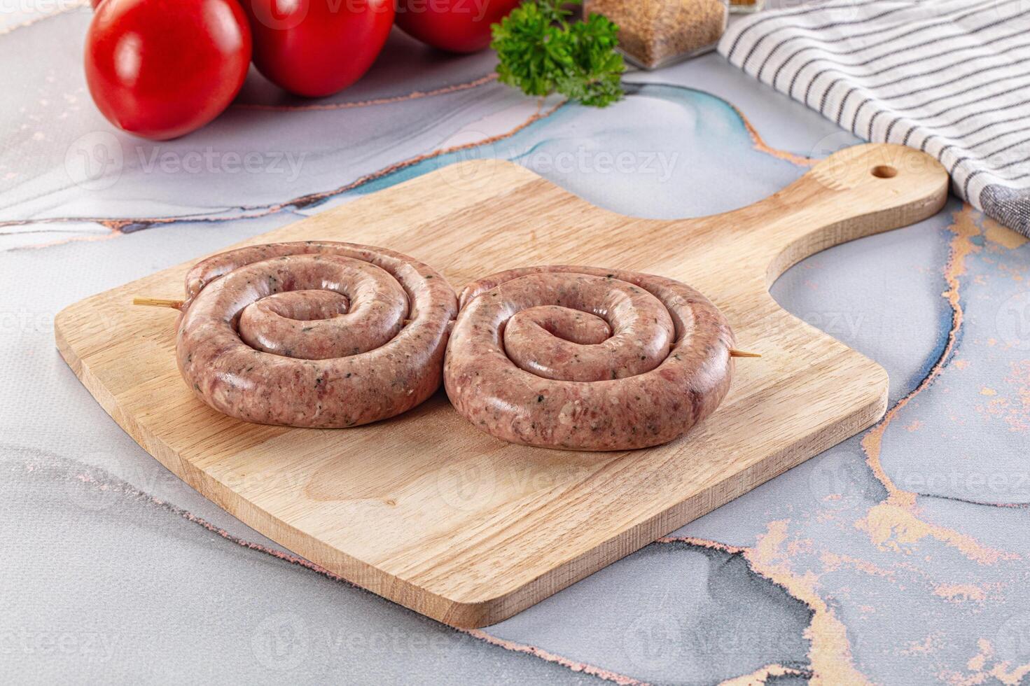 Two sausage rolls on a wooden cutting board photo