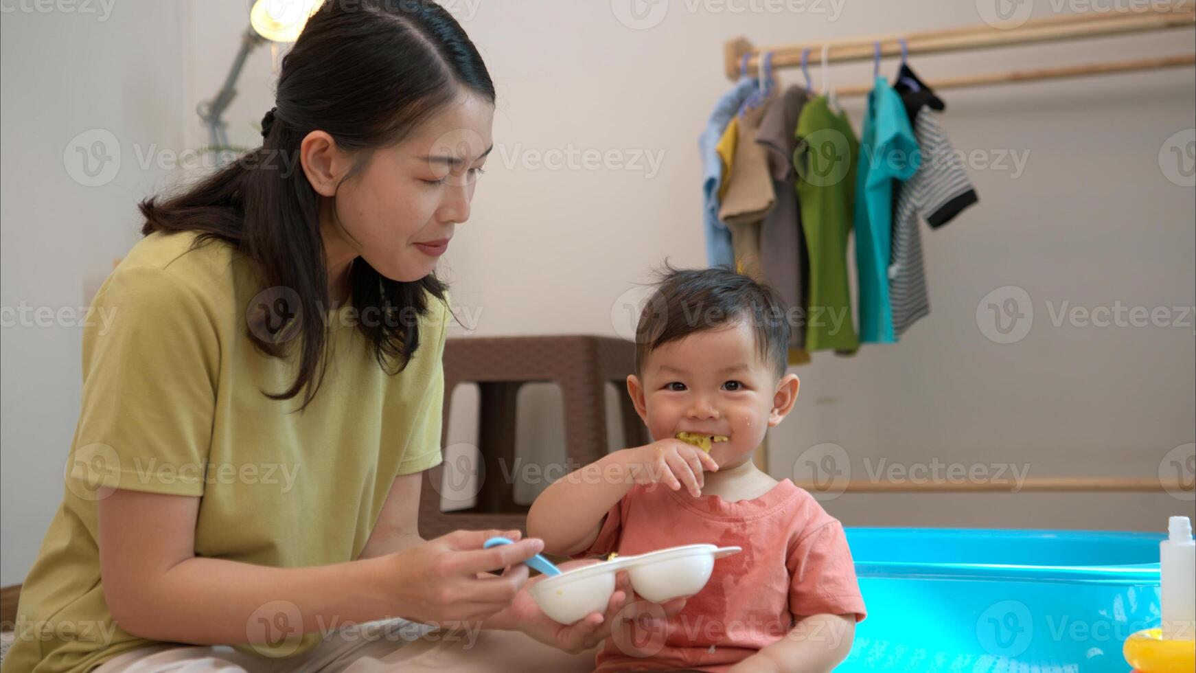 Little boy with breakfast with mom feeding him before bathing him,325 photo