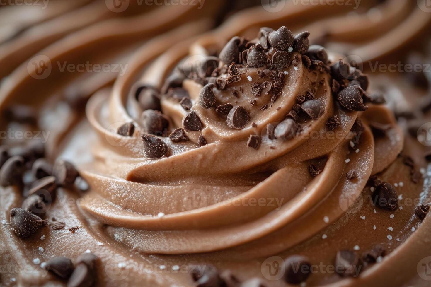 Chocolate ice cream topped with chocolate shavings is sitting on a wooden table photo