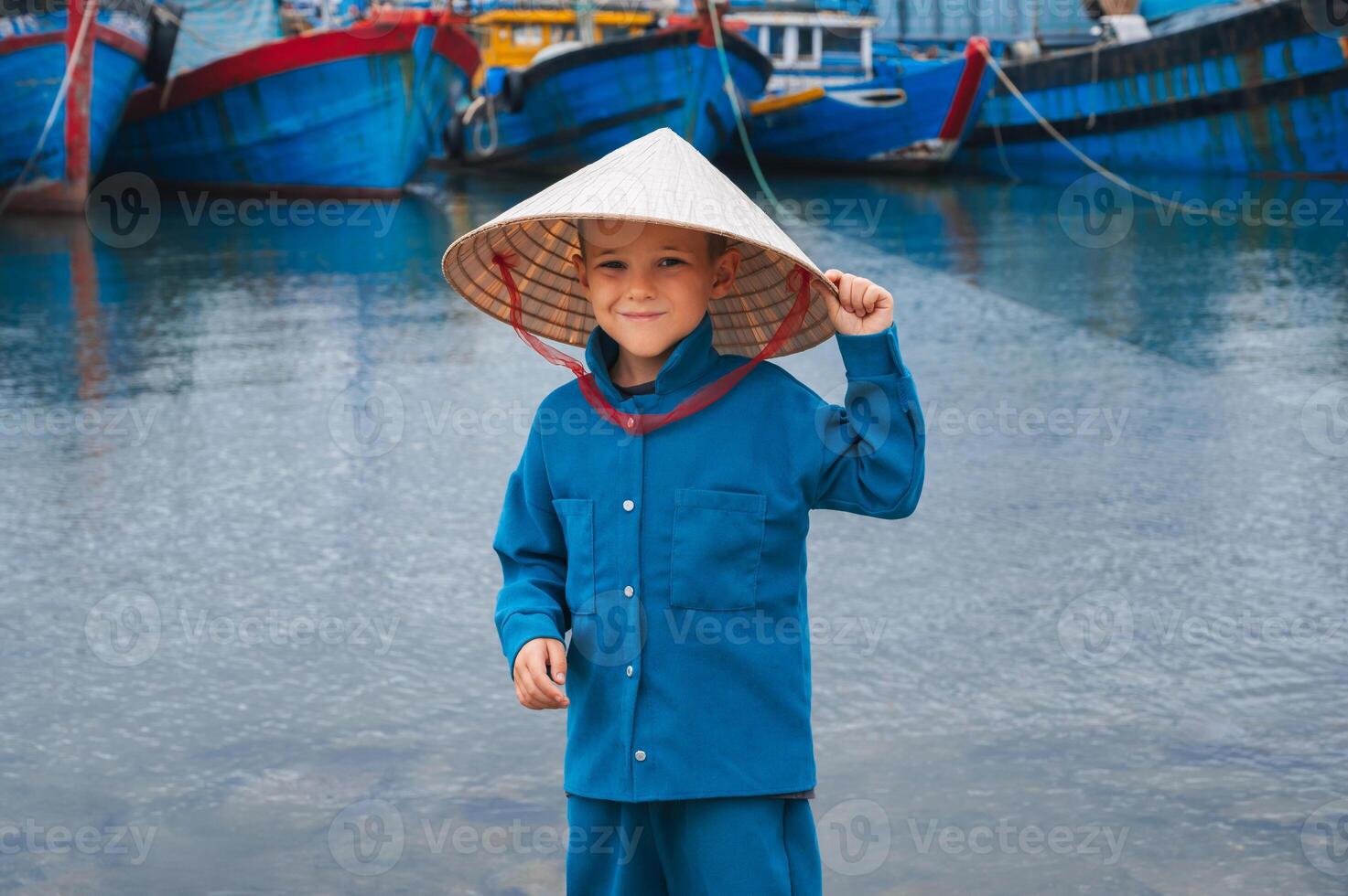 A child traveler inspecting traditional wooden boats in the port of Da Nang. photo