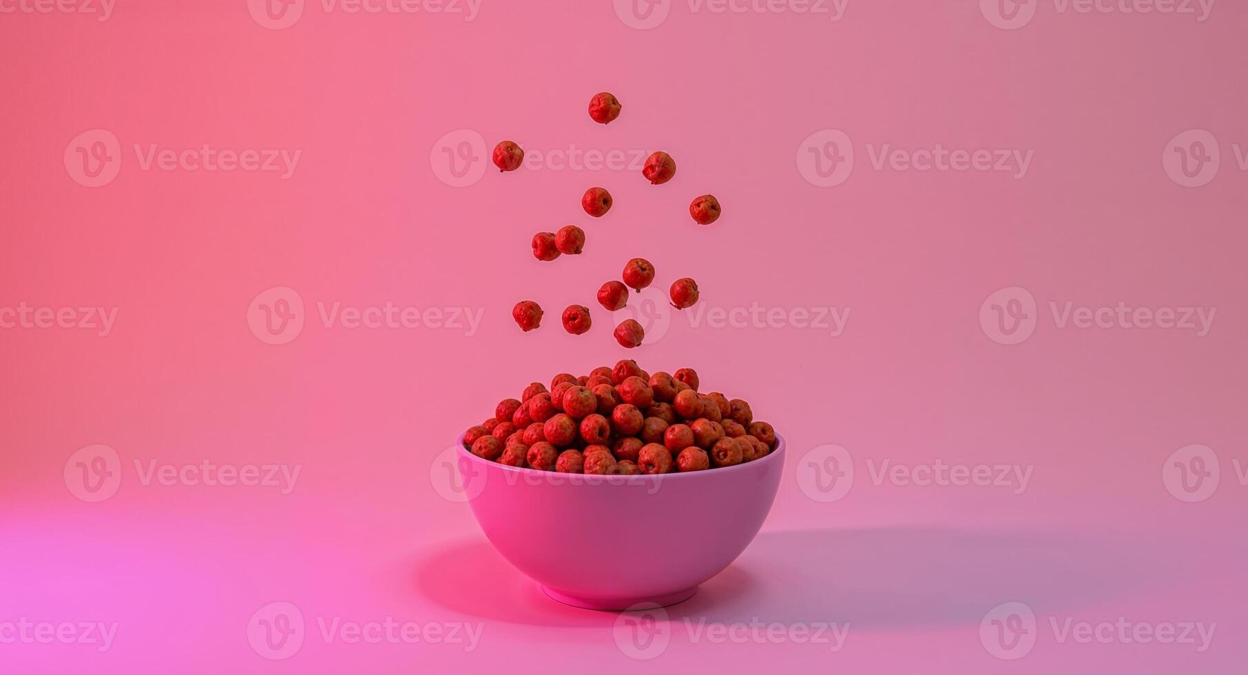 A bowl full of red apples falling into a pink light photo