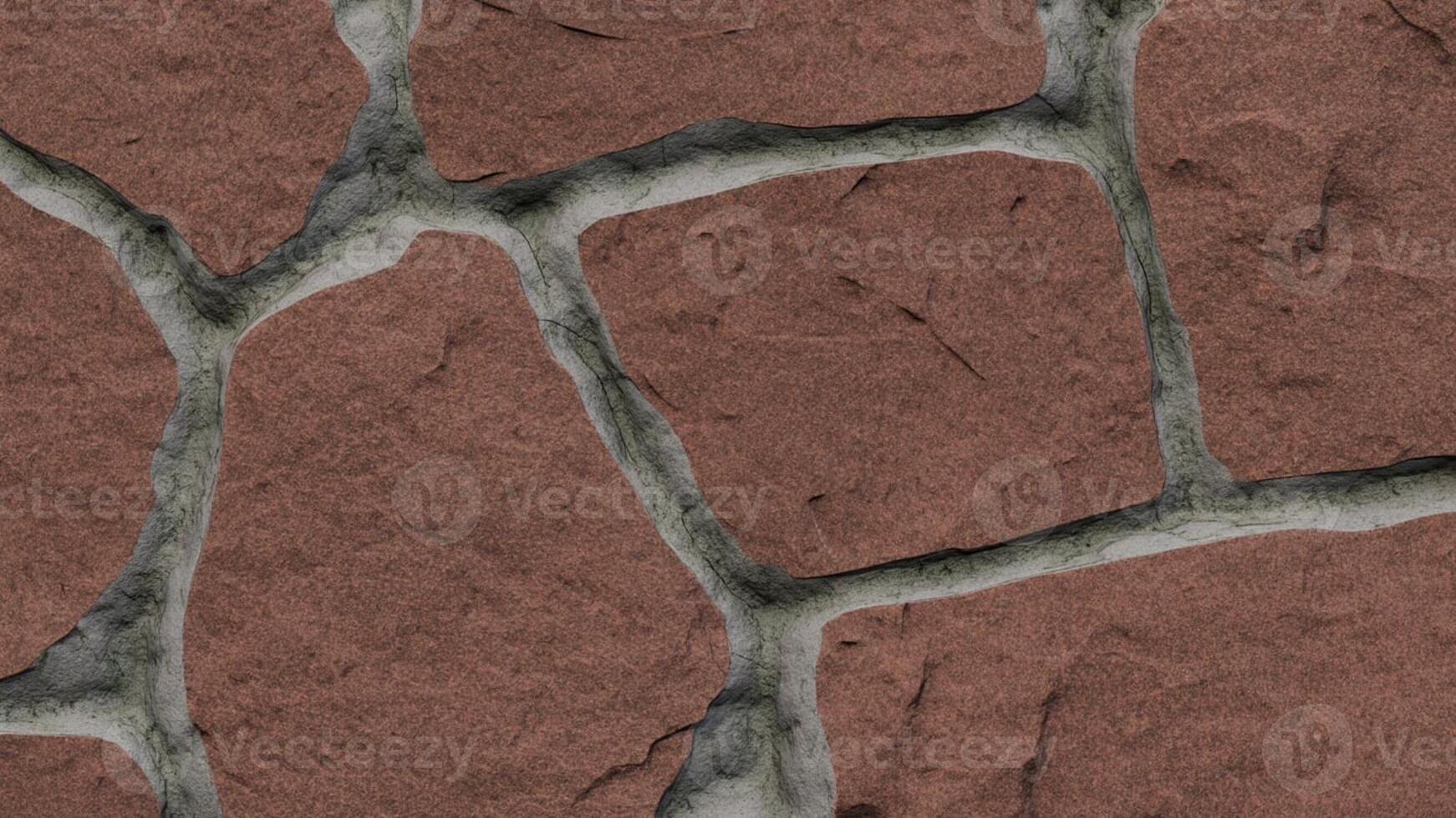 Close up shot of a red stone wall with grey mortar filling the gaps in between the stones photo