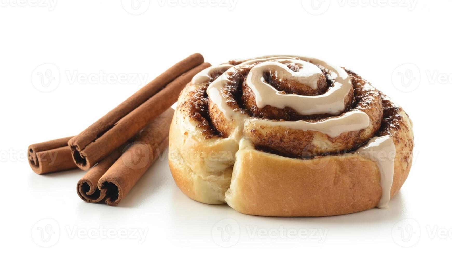 Close up shot of a cinnamon roll with white icing and cinnamon sticks on white photo