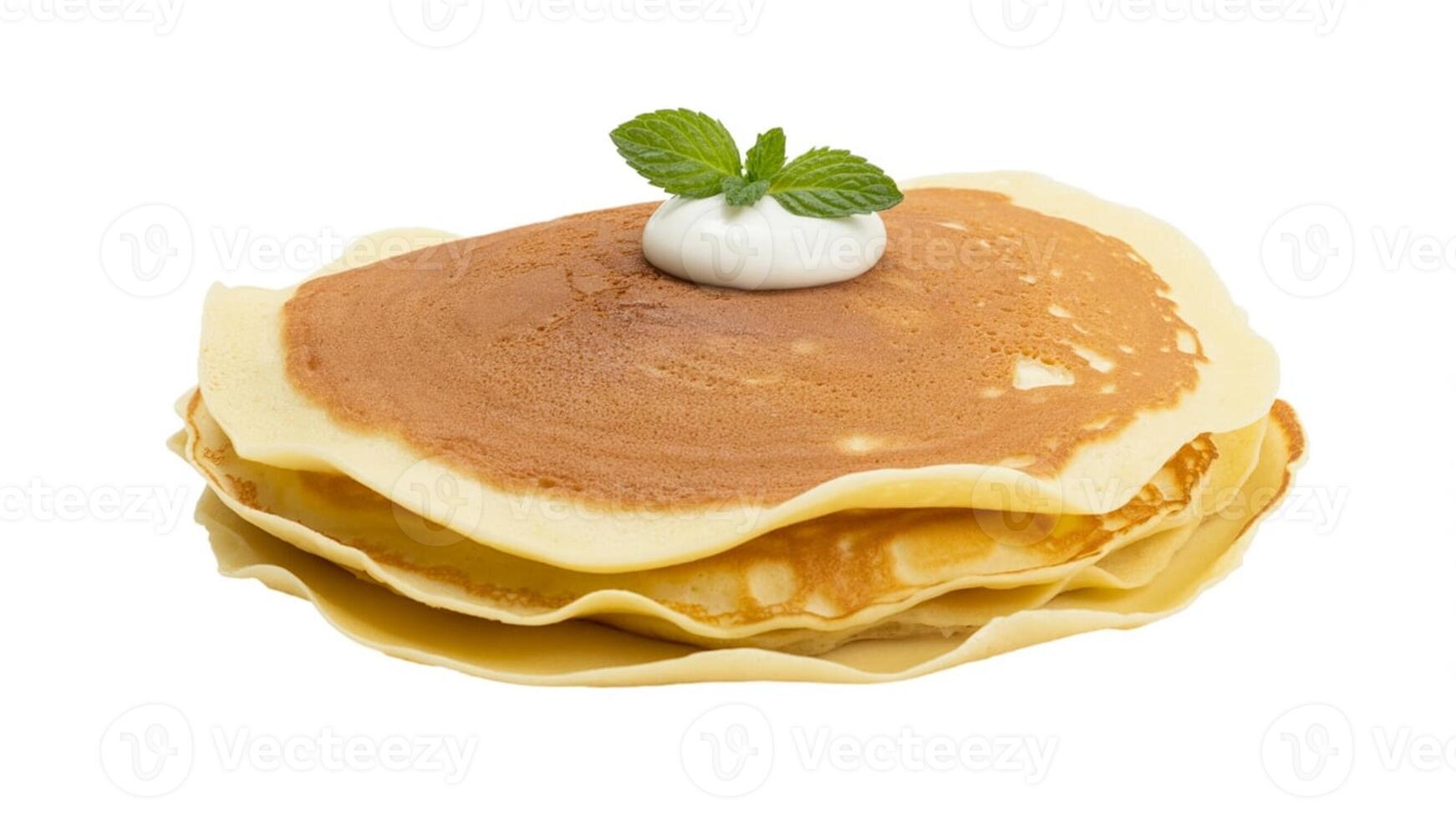 Stack of pancakes topped with cream and mint leaves on a white background, isolated view photo