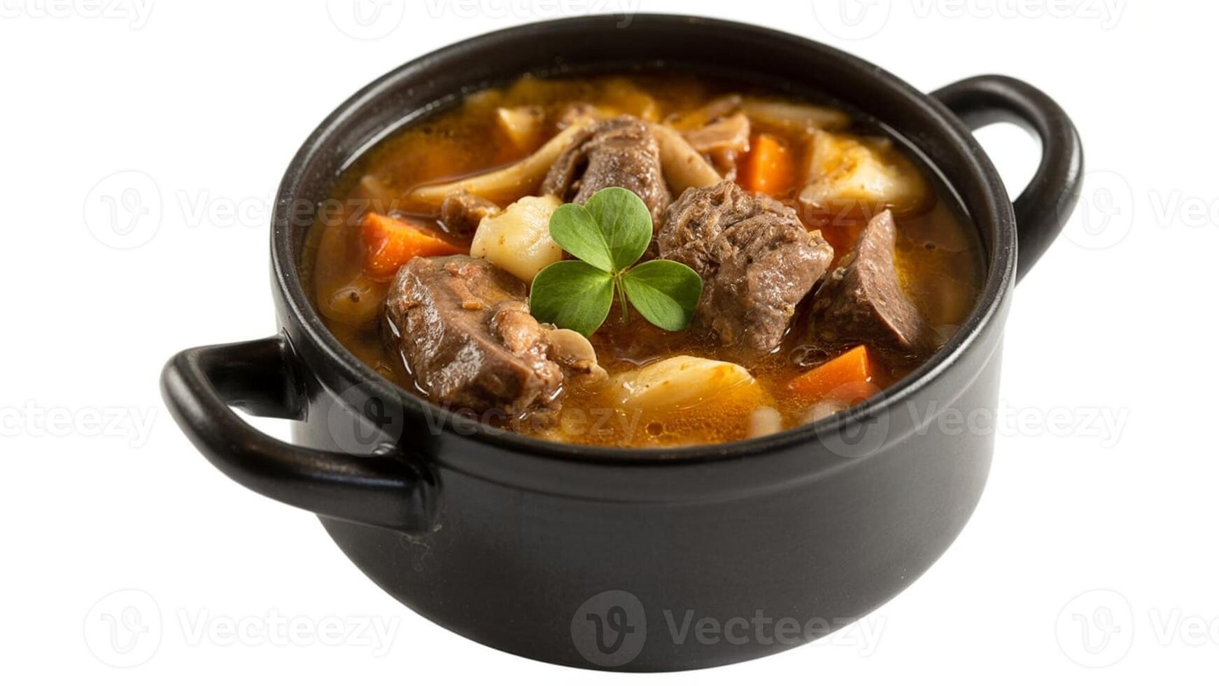 A close up shot of a black pot filled with irish stew and topped with a shamrock leaf photo