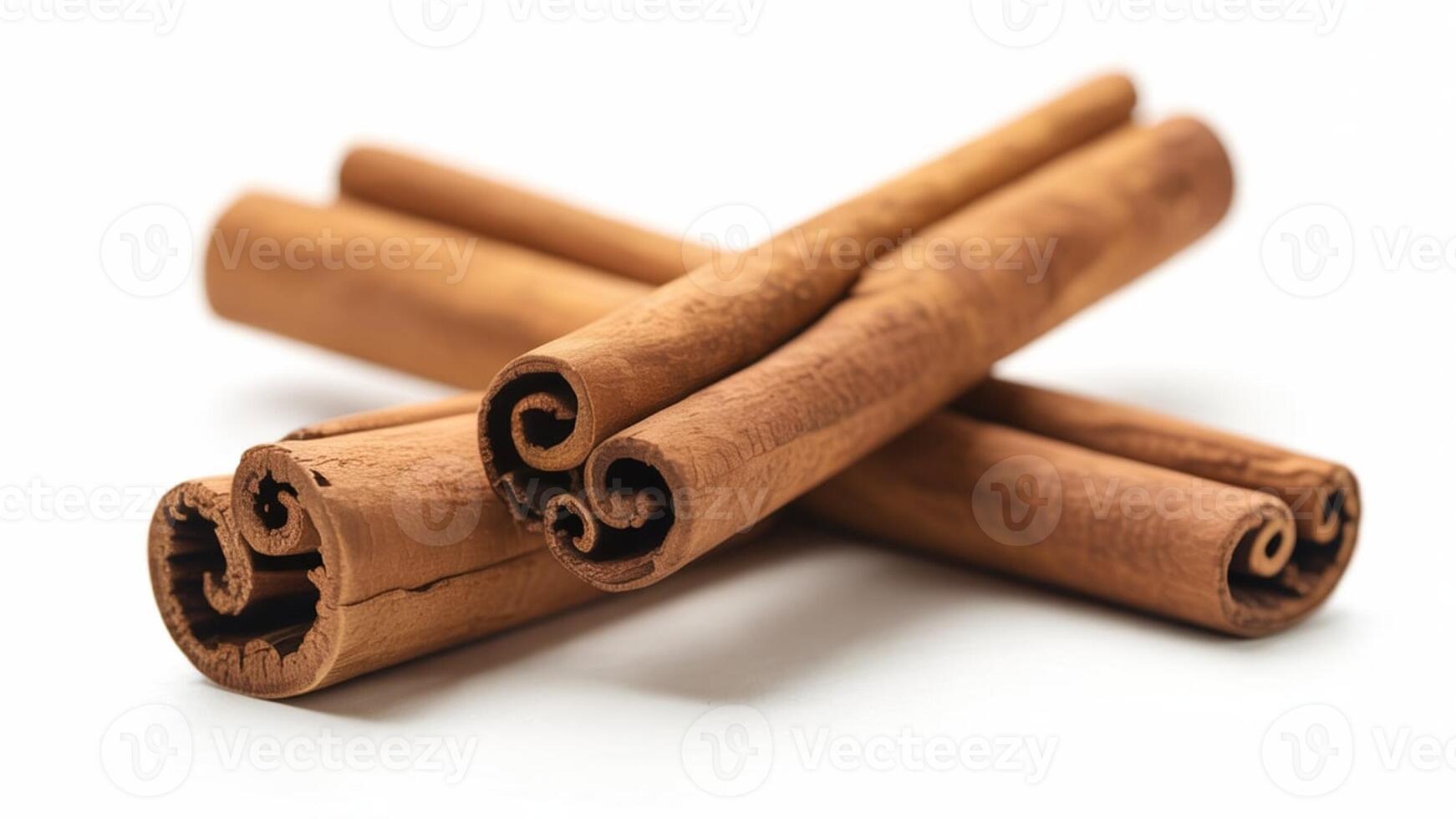 A close up shot of several cinnamon sticks lying on a white surface in a studio setting photo