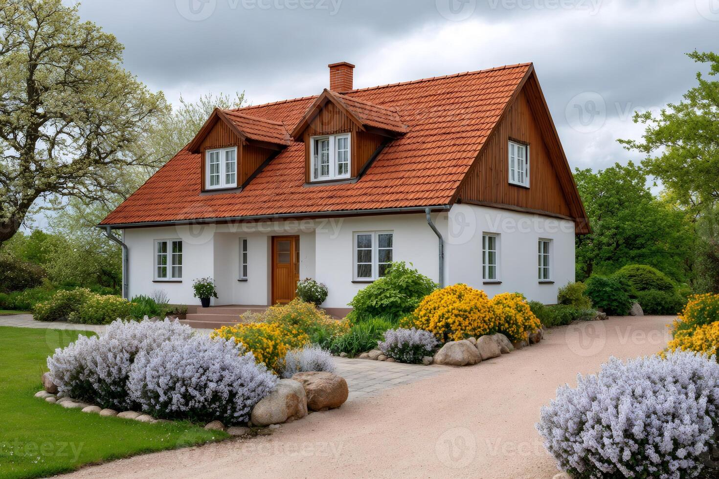 Beautiful white house with red roof and blooming garden during spring photo