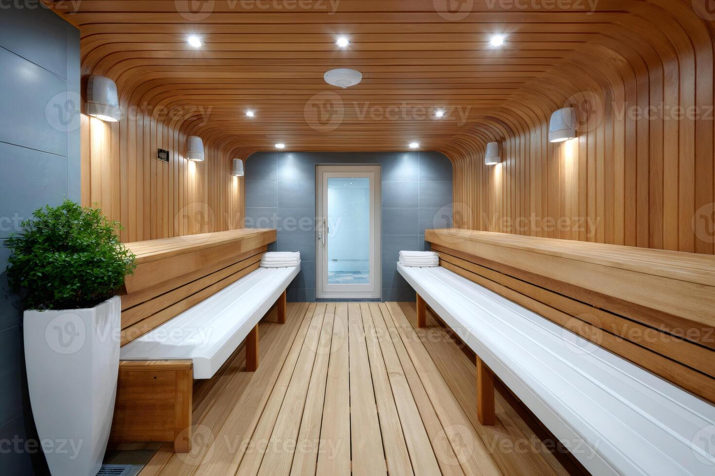 Empty modern sauna room inviting to relax with white towels and wooden benches photo