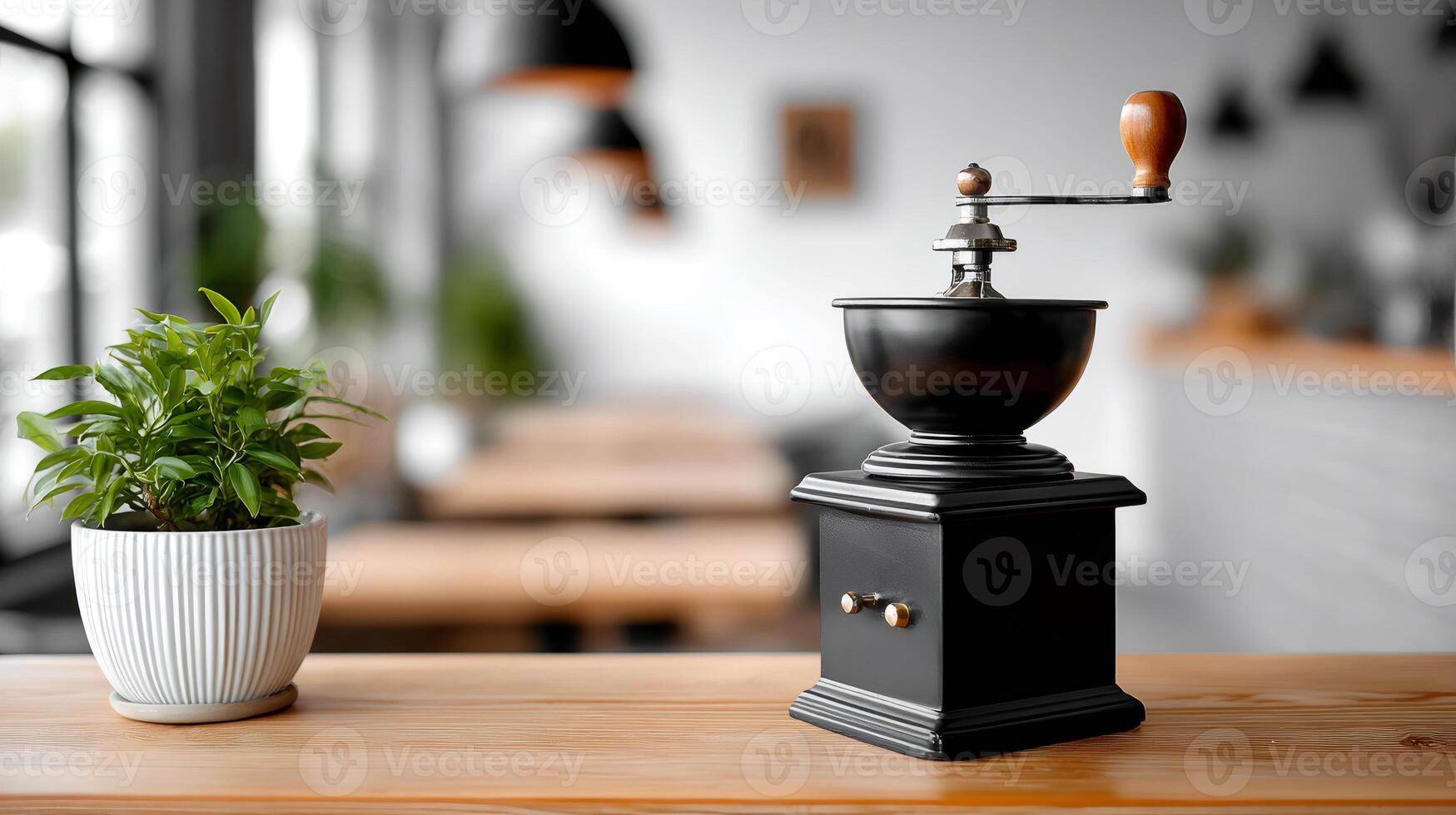 Manual coffee grinder sitting on a wooden table in a cafe photo