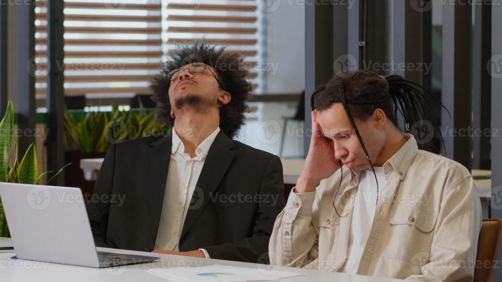 Two African American men business guys colleagues desperate stressed worried businessmen coworkers working together internet laptop at office online failure sad bad news computer problem notification photo