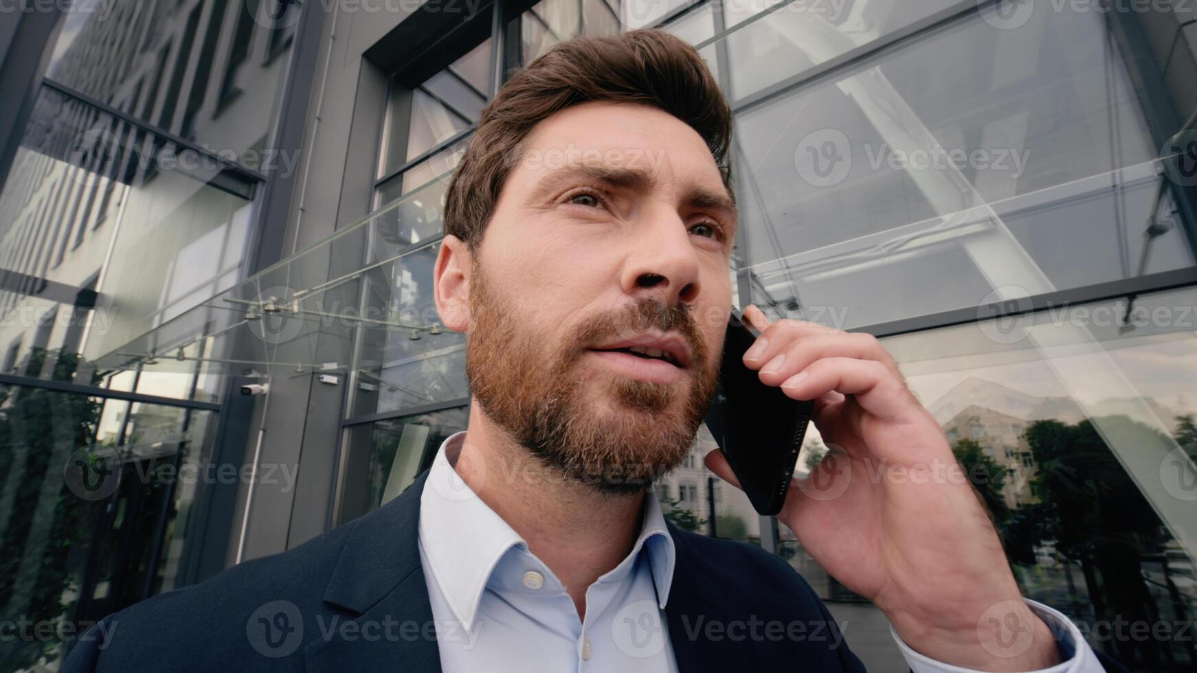 Middle-aged Caucasian business man screaming yelling angry to mobile phone talking call problem argument quarrel near office building in city businessman male talk smartphone work stress fury job photo