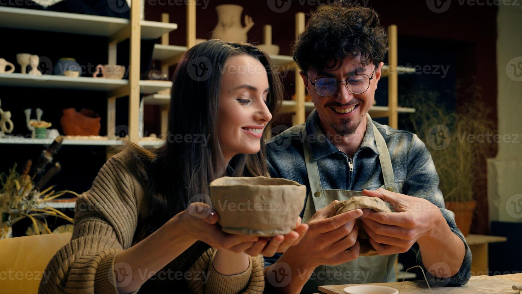 Couple enjoying pottery in a studio photo