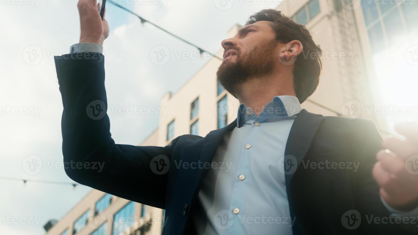 Middle-aged Caucasian business man confused with mobile phone lost signal Wi-Fi connection problem in city frustrated businessman male outside office holding smartphone searching connect online fail photo