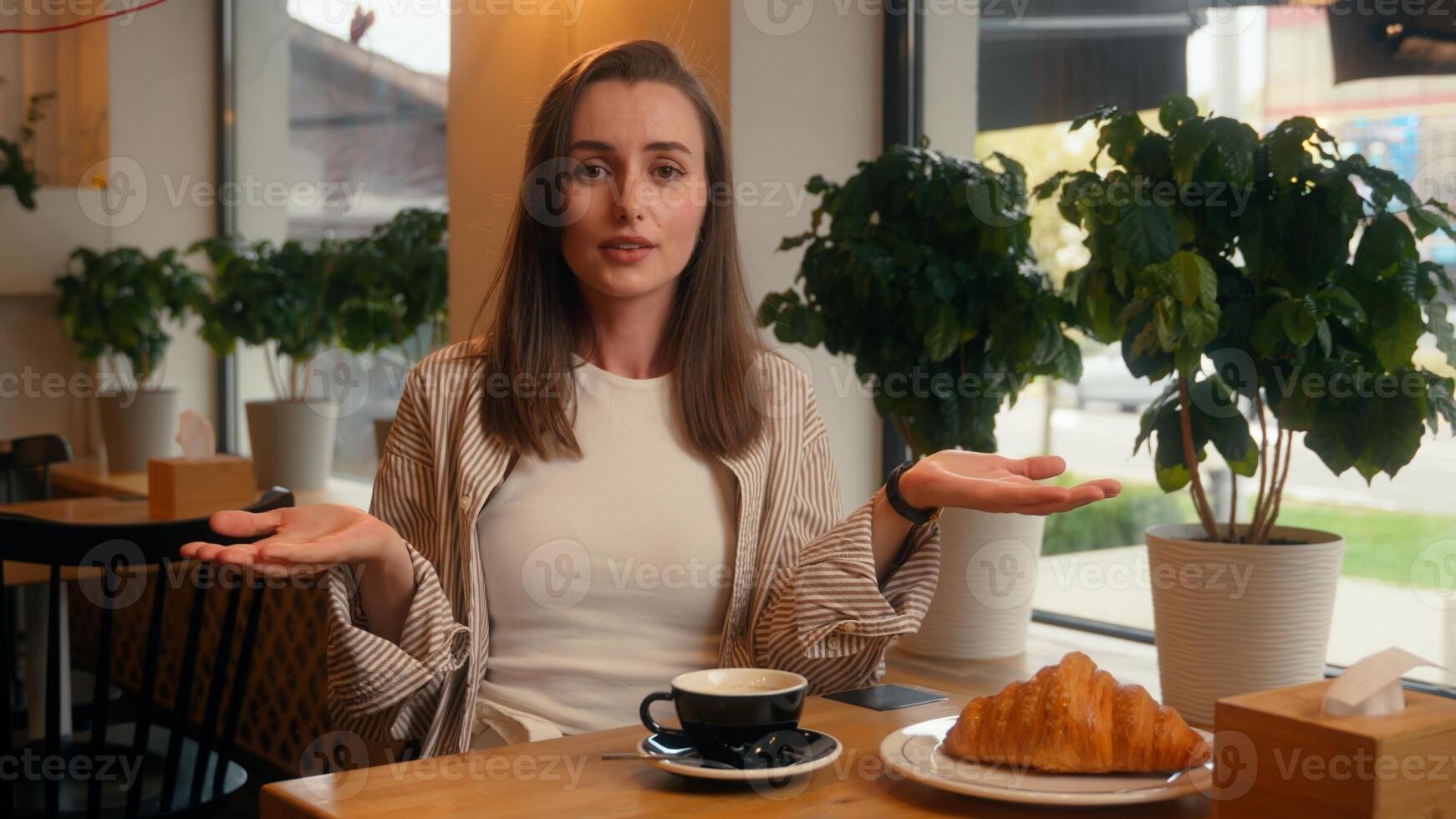 Caucasian woman in cafe looking in window waiting canceled date sad frustrated lonely girl female at cafeteria table shrugging shoulders upset at camera delay late wait impatient lateness meeting photo