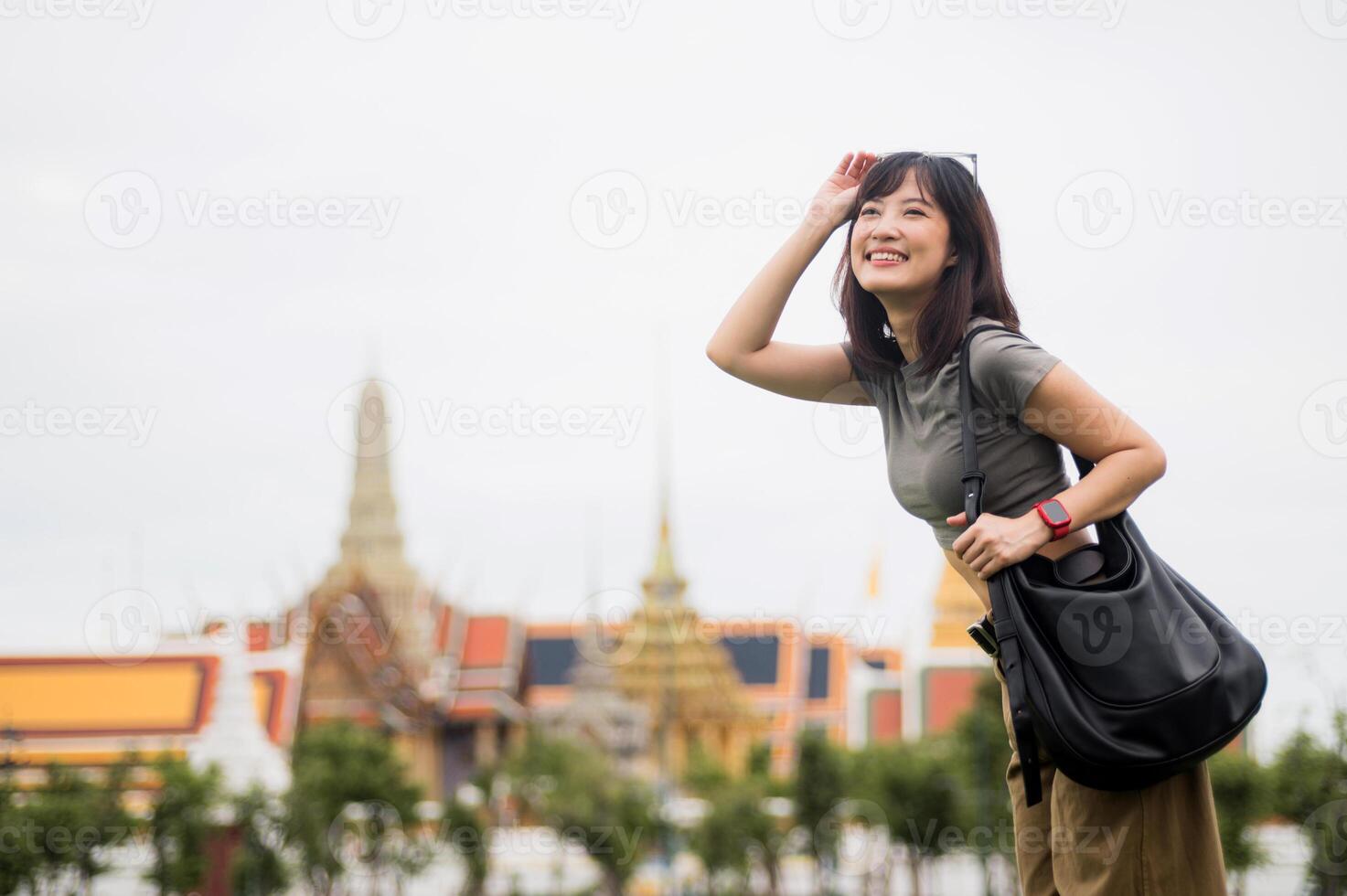 Happy solo Southeast Asian woman teenage blogger and world travel explorer enjoys local cultural tourism experience in Bangkok Thailand. concept for travel in Asia photo