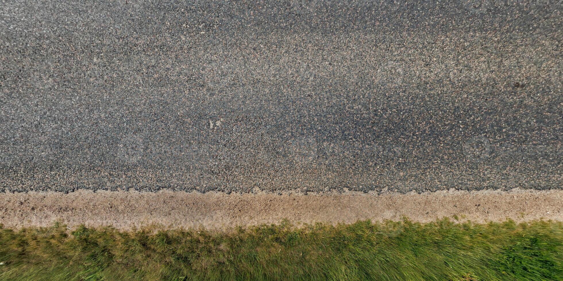An aerial view of a road with grass and dirt photo