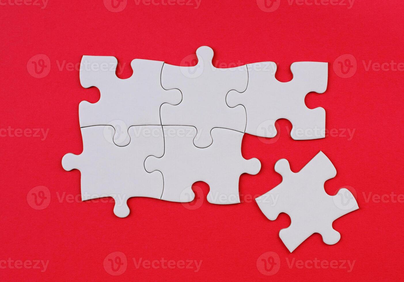 White Puzzle Pieces on Red Background. Missing Piece Concept. Stock photo. photo