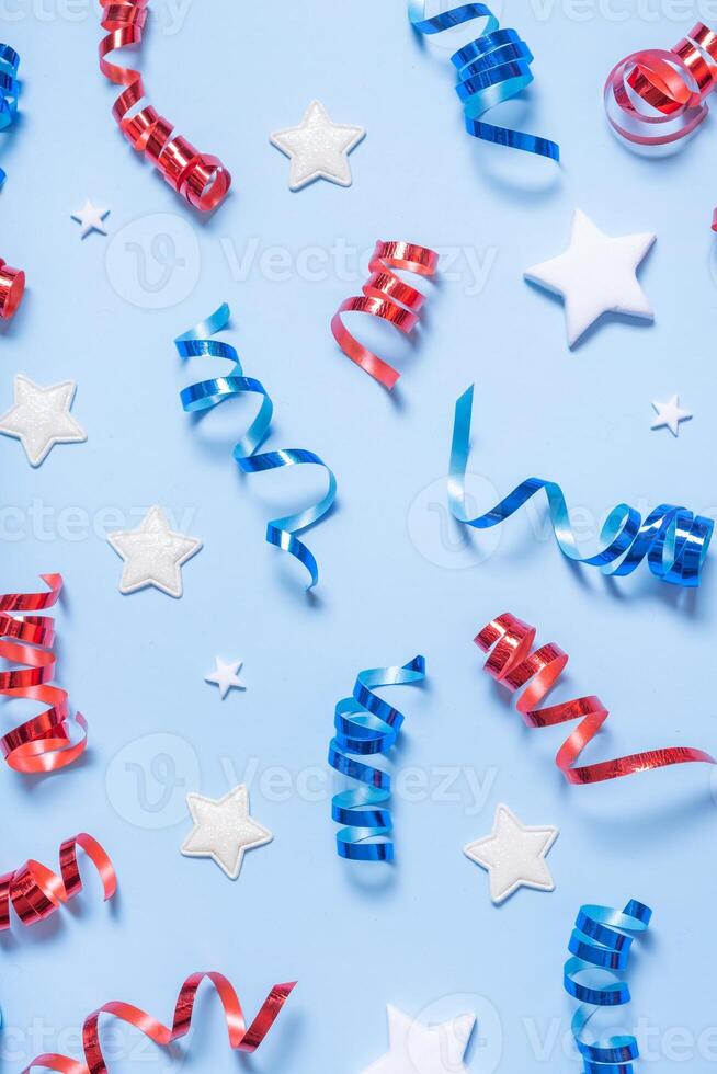 USA Independence day backdrop. Red and blue spirals and white stars elements of USA flag top view, flat lay on blue background photo