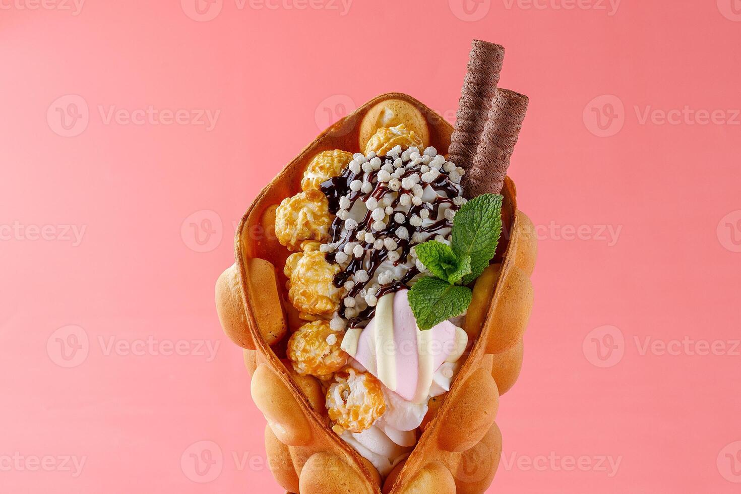 Gourmet Bubble Waffle Cone with Caramel Popcorn and Mint photo