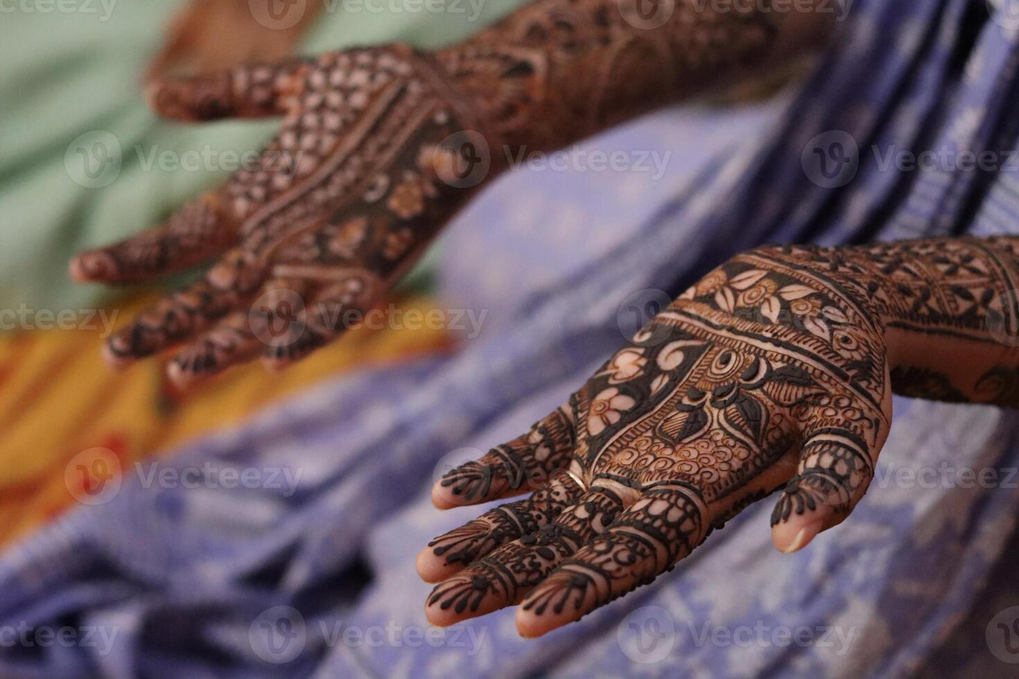 A closeup view of a girl hands adorned with intricate mehndi henna designs, a traditional Indian body art often applied during weddings, festivals, and celebrations. photo
