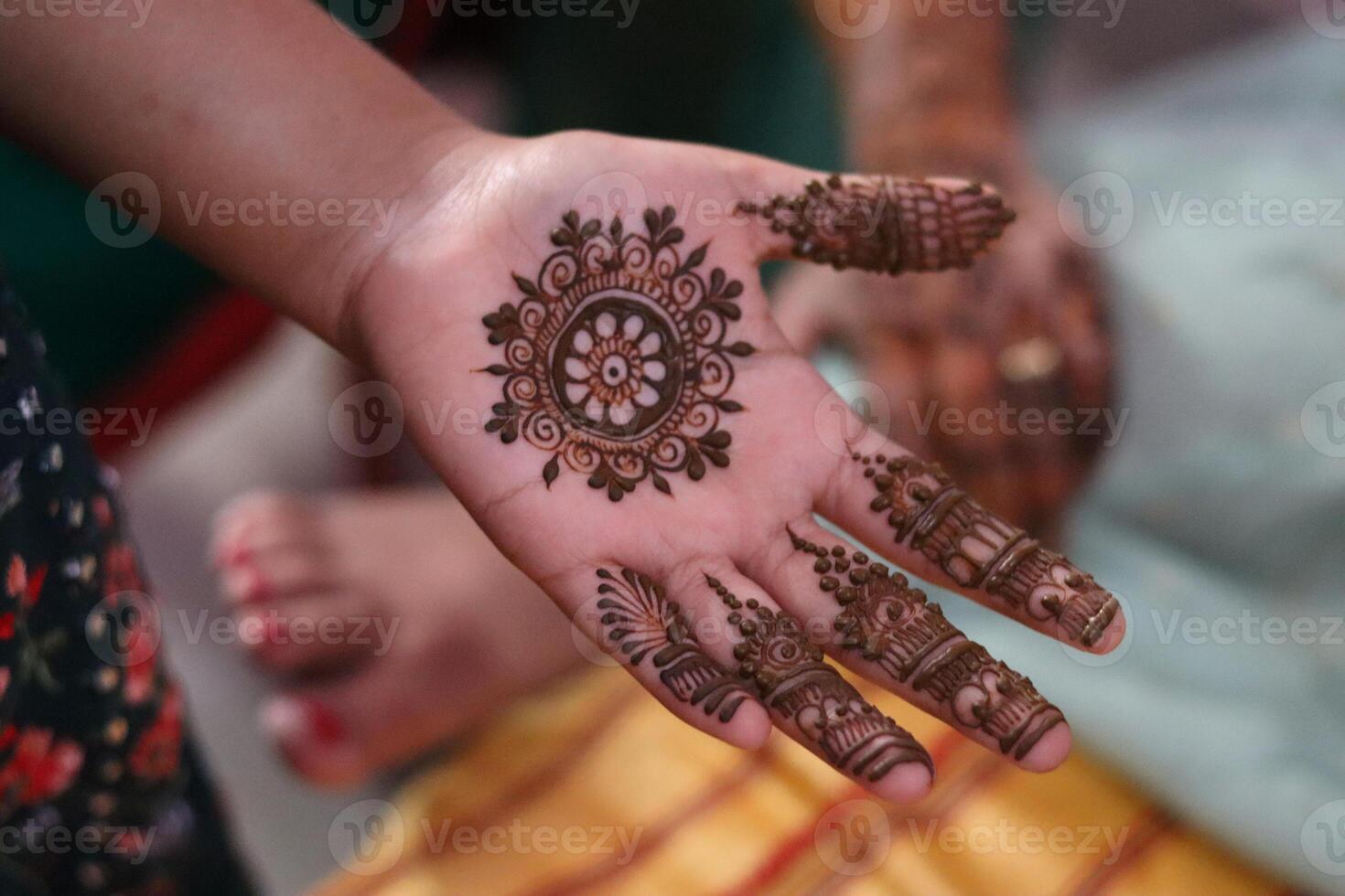 A single hand of a young girl displays a beautiful circular mandala style mehndi henna design. The image captures the elegance and symmetry of traditional Indian body art photo