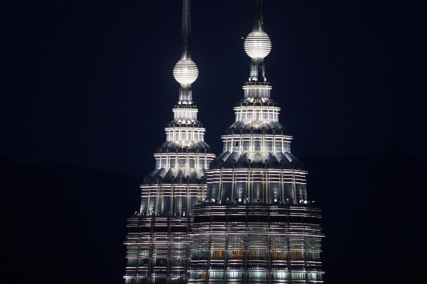 23rd June 2024 Kuala Lumpur, Malaysia Close-up night view of the Petronas Twin Towers in Kuala Lumpur, showcasing their modern architecture and stunning illumination. photo