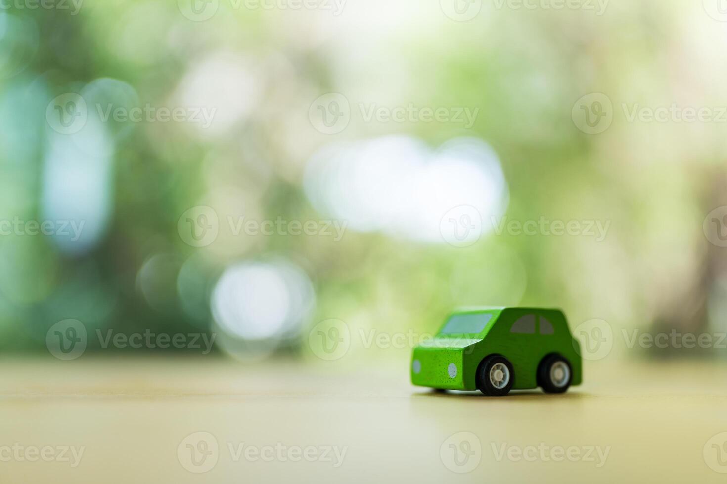 Green wooden toy car on wood table. photo