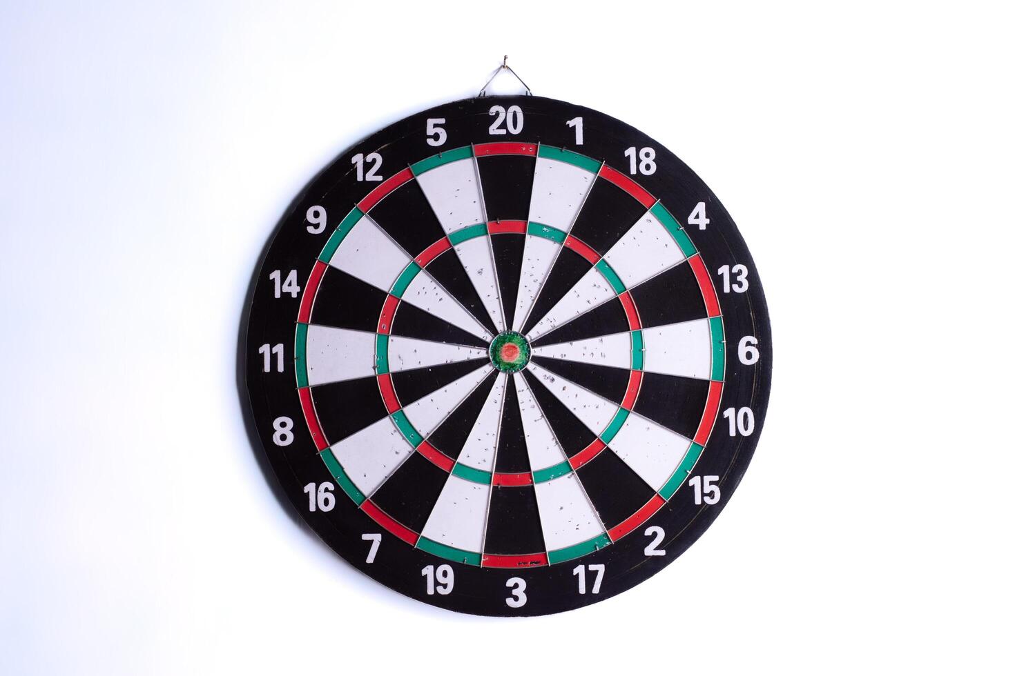 Classic dartboard isolated on white background. Target bullseye board for darts game, accuracy and goal concept. Sports equipment for competition, strategy, and achievement motivation. photo