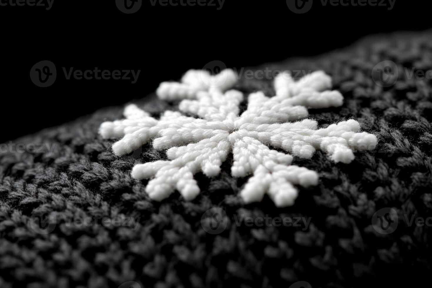 A close up of a knitted snowflake on a black background photo