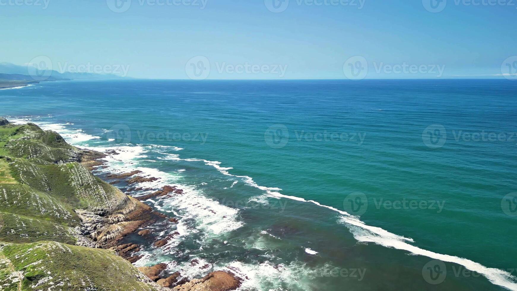 Breathtaking aerial shots that beautifully showcase the tranquil ocean waves and vibrant green landscapes photo