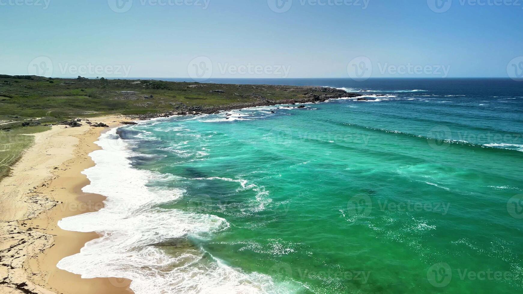 Experience the beauty of turquoise waters blending with soft sandy shores in this tranquil coastal scene. photo