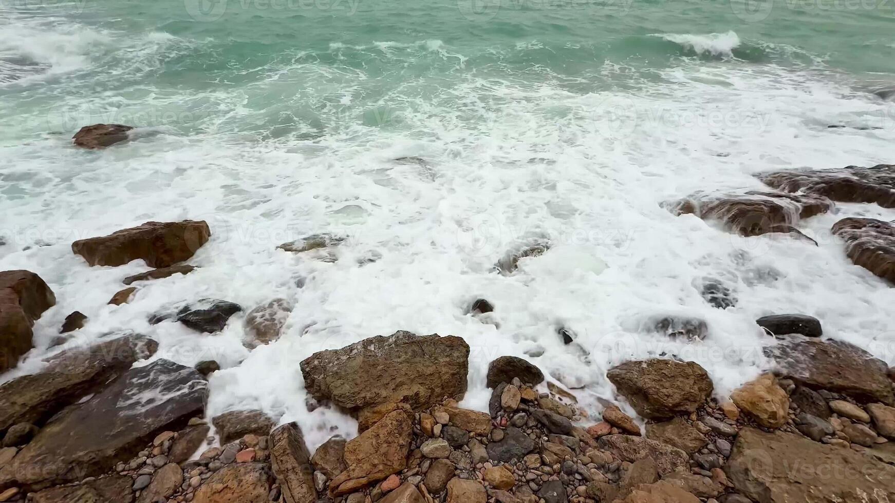 The beautiful waves elegantly crash on the rocky shores, showcasing the breathtaking power and tranquility of nature photo