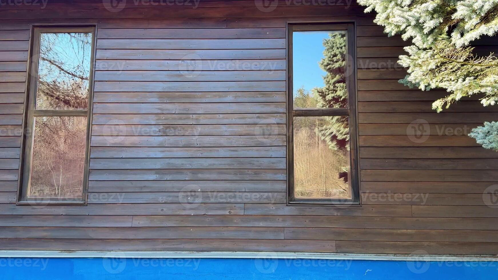Explore the sleek design of this remarkable wooden house with clear reflections and beautiful surroundings photo