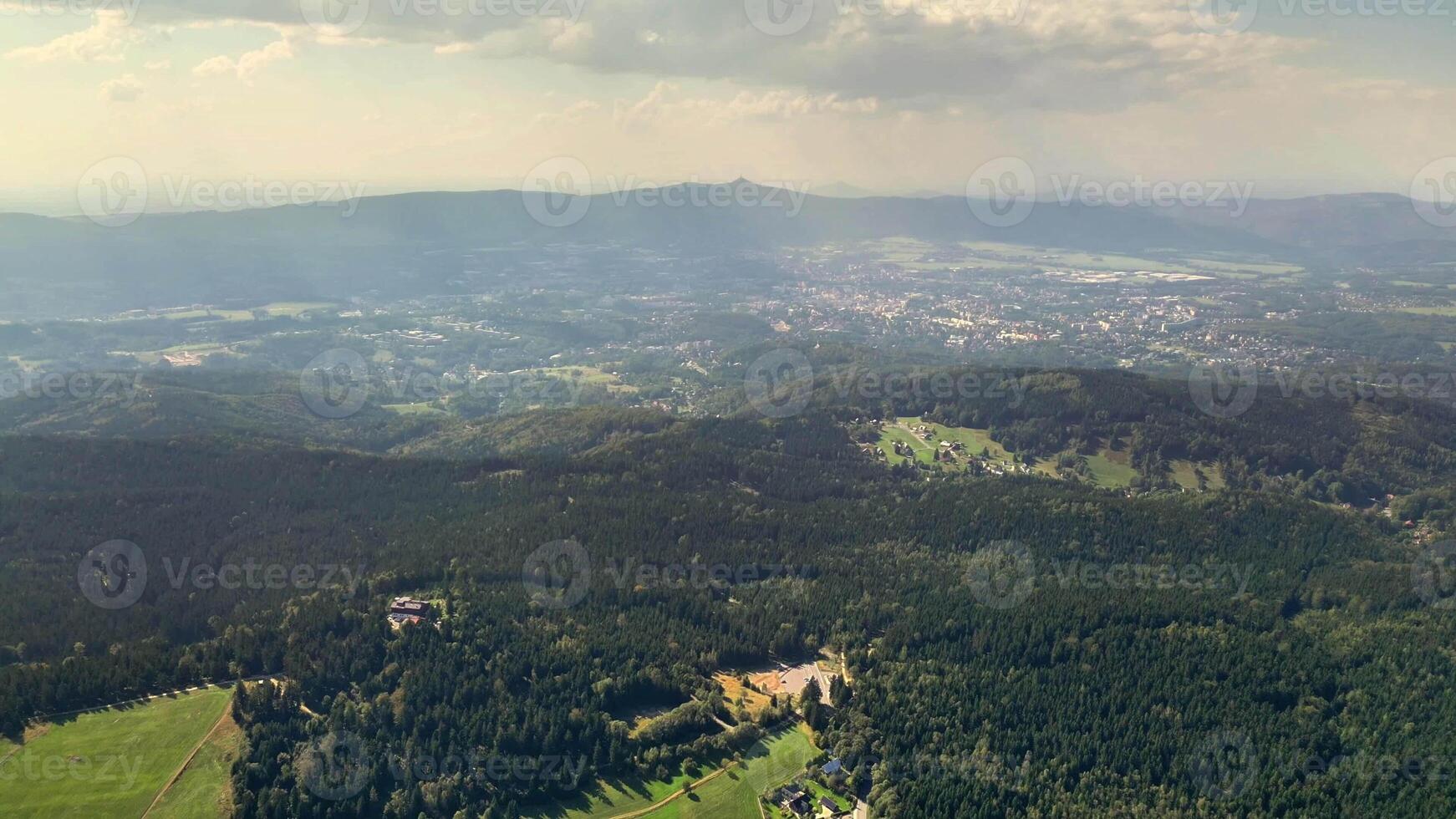 A stunning aerial view showcasing the expansive green mountains alongside the beautiful and serene valleys below photo