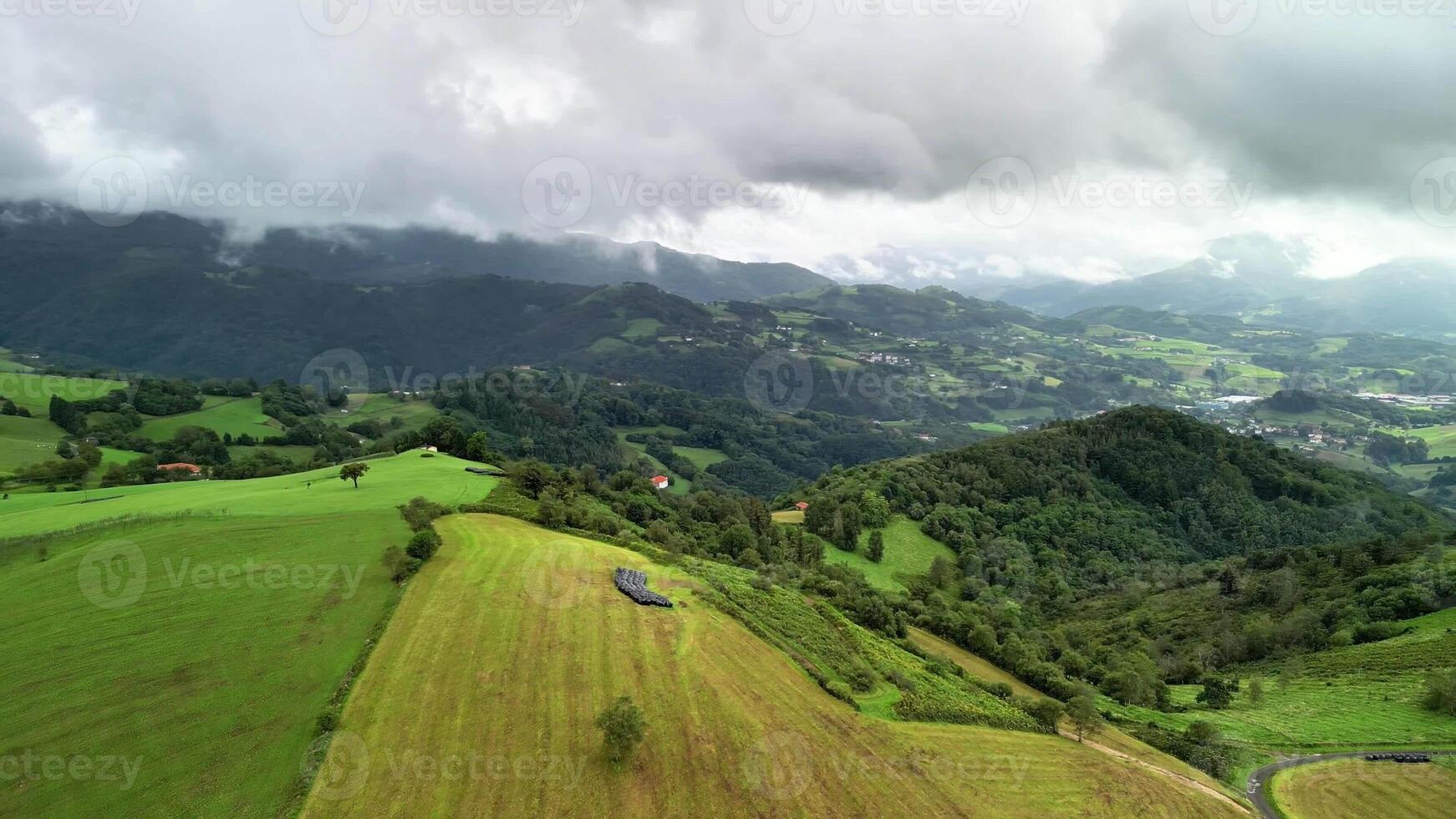 Experience the breathtaking aerial view of stunning landscapes showcasing green hills and valleys beneath cloudy skies photo