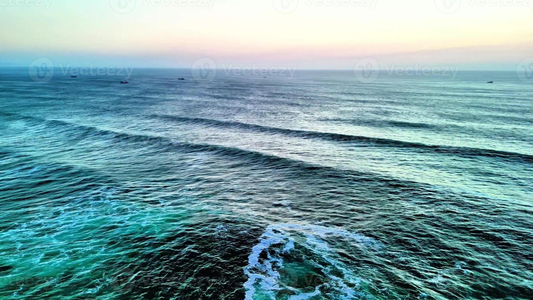 A breathtaking view of the ocean waves in calming colors during sunset, perfect for relaxation visuals. photo