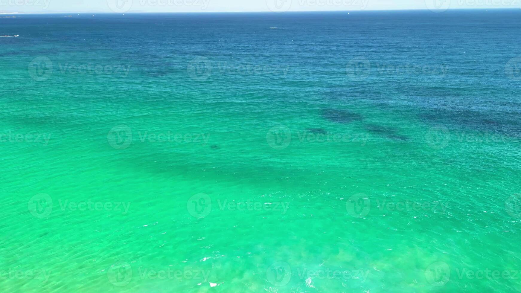 Breathtaking aerial footage beautifully capturing the vibrant turquoise waters and the serene waves of the ocean photo