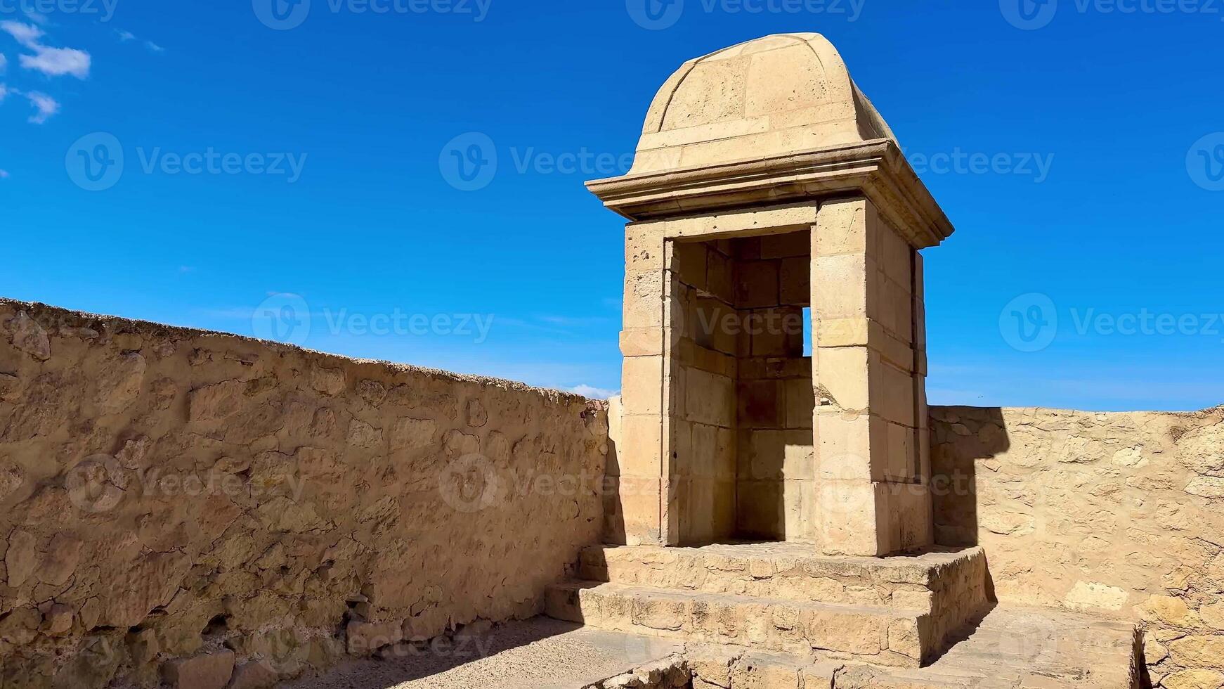 A stunning ancient stone structure against blue skies, showcasing impressive historical architecture photo